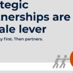 Partnership strategy meeting between B2B leaders discussing high-performing alliances